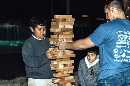 A family plays oversized Jenga at Sights and Sounds of Christmas.