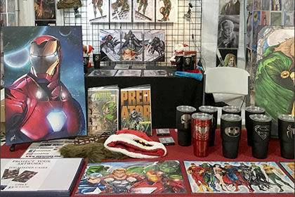 Marvel fan art is on display at a vendor booth in Santa's Gift Shop.