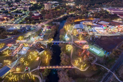 An aereal shot shows the entire festival grounds lit up at night.