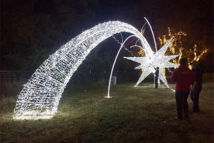 A giant shooting star decoration lights up the festival grounds.